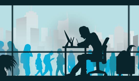 man sitting at desk working while there is a bunch of people outside